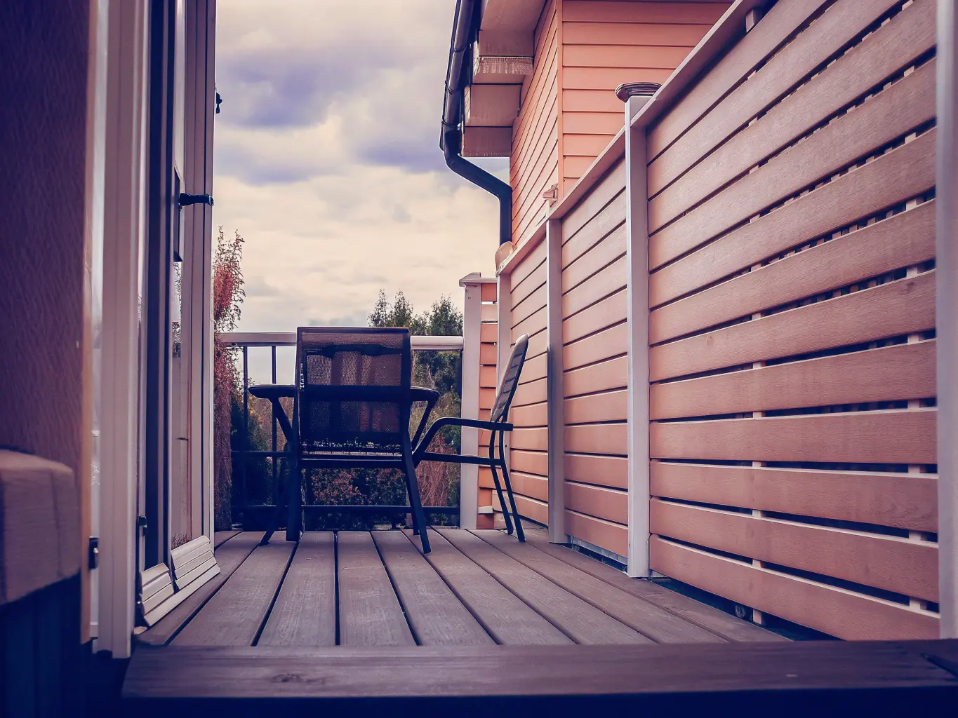 Staket runt uteplats med utemöbler men inga personer